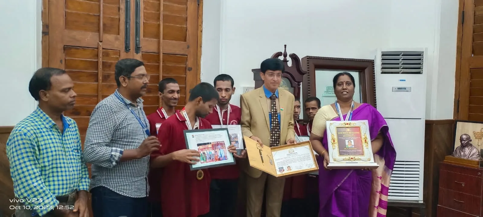 Hope Chennai students receiving certificates and framed artwork at a government office
