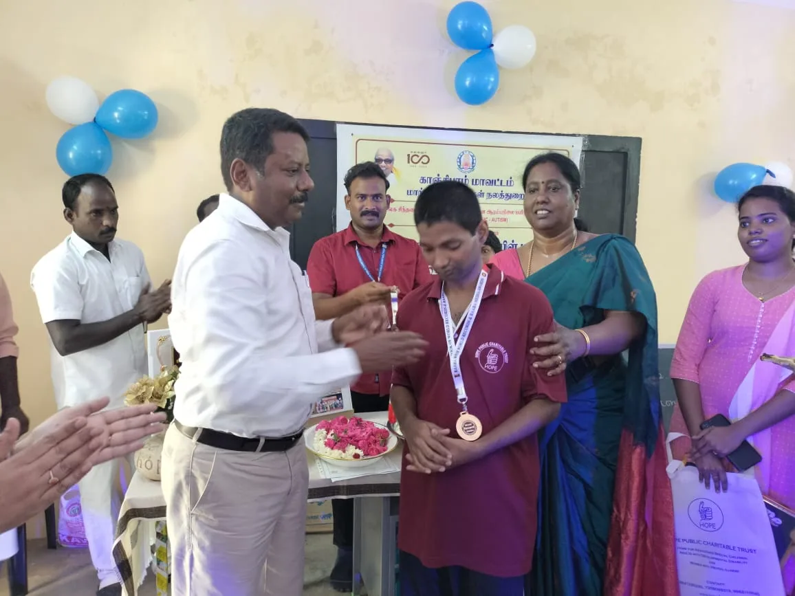 Hope Chennai student receiving a medal from a guest at a district function
