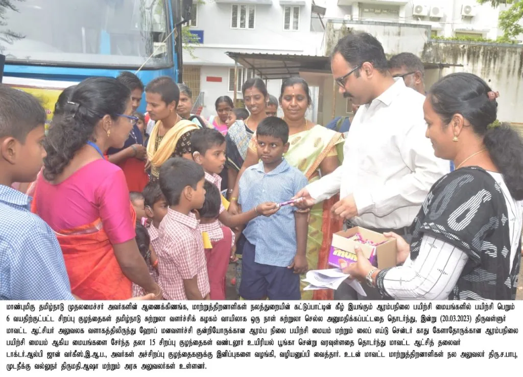Official distributing gifts to children at the bus service launch