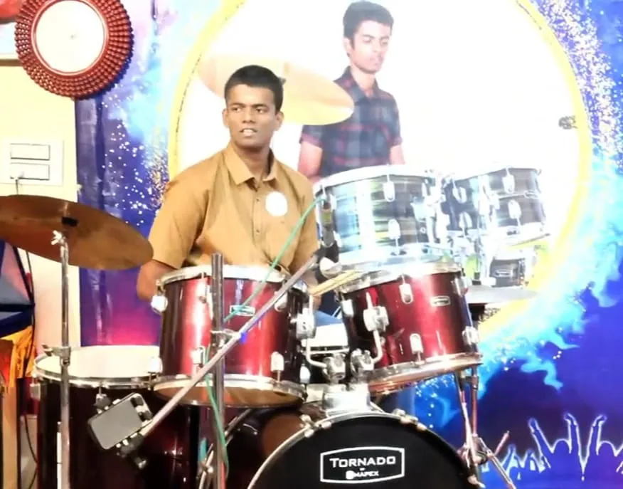 Student drummer performing on stage at the Hope Chennai drumming marathon