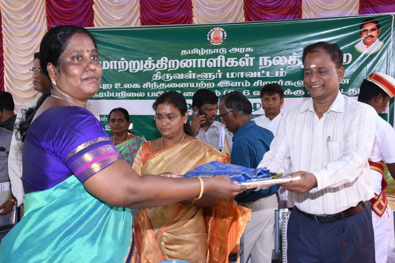 Hope Chennai founder receiving a gift from an official at a disability welfare event