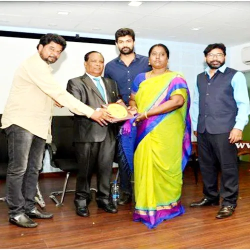 Hope Chennai founder receiving a memento from guests at an award event