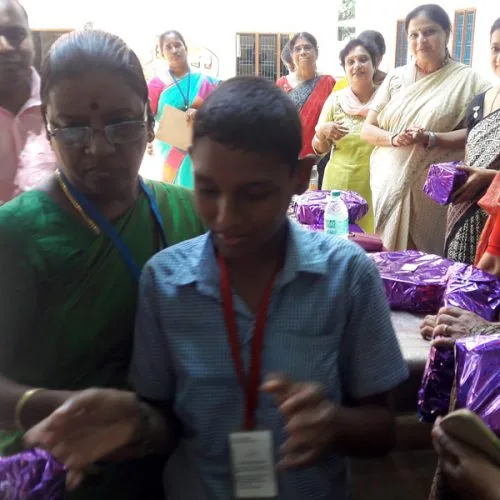 Hope Chennai student receiving a gift from guests at the school