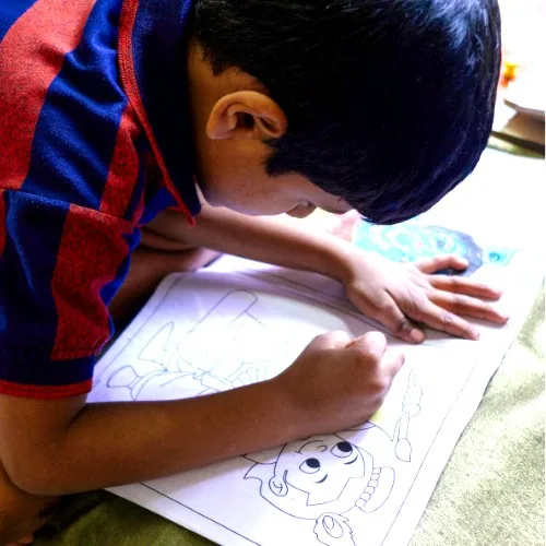 Child colouring a drawing at Hope Special School