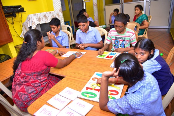Special educator working with children on learning activities