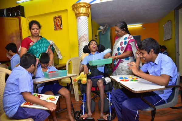 Teachers caring for children with cerebral palsy during activities