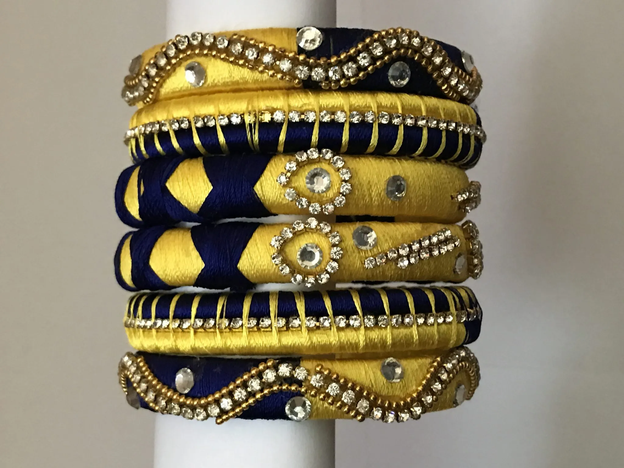 Handmade yellow and navy blue silk thread bangles with stones
